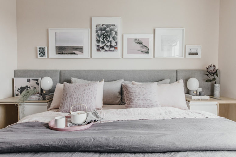 The master bedroom has an upholstered bed, comfy nightstands and monochrome artworks