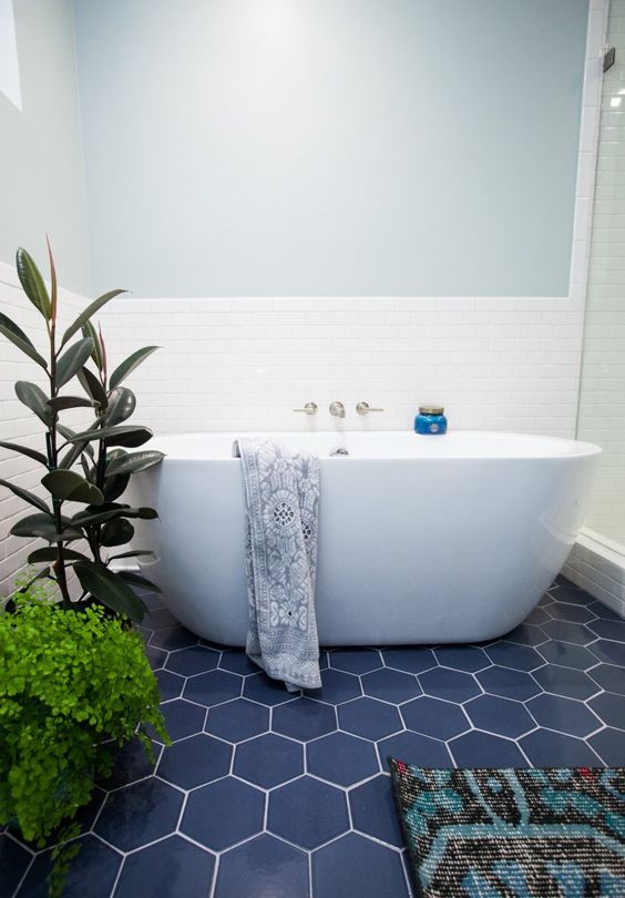 navy hex tiles with white grout give a seaside look to the bathroom