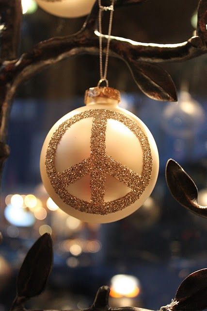 a pastel ornament with a glitter peace sign can be made by yourself