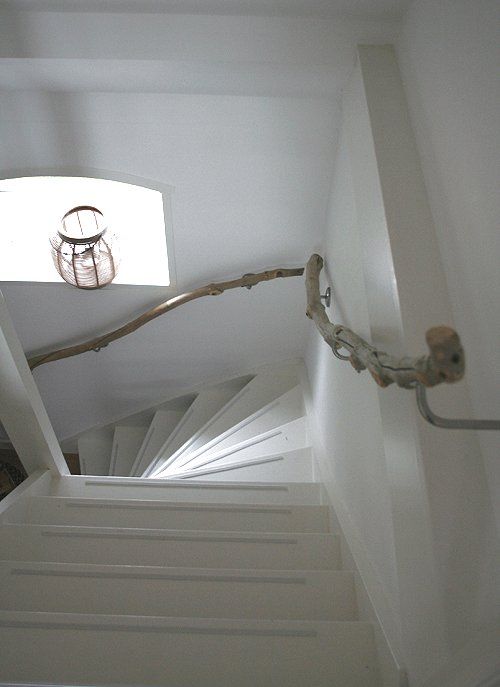 driftwood branches for handrails will give your stair a beach feel