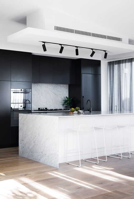 minimalist black and white kitchen with track lights