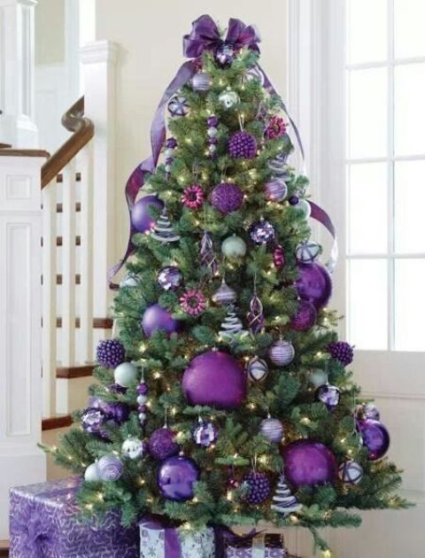 purple Christmas tree with oversized glitter ornaments and smaller ones
