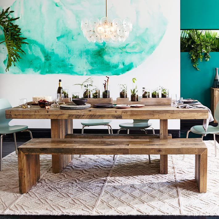 reclaimed wooden table and benches contrast with modern watercolor wall art