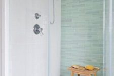 10 glass-enclosed shower with a green tile accent wall