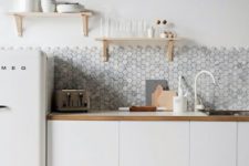 10 grey hex tile backsplash contrasts with white cabinets