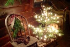 10 lit up christmas tree on a wooden sleigh