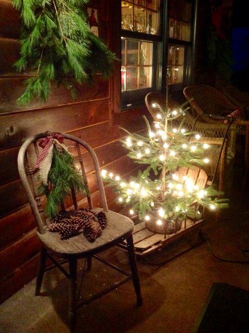 lit up christmas tree on a wooden sleigh