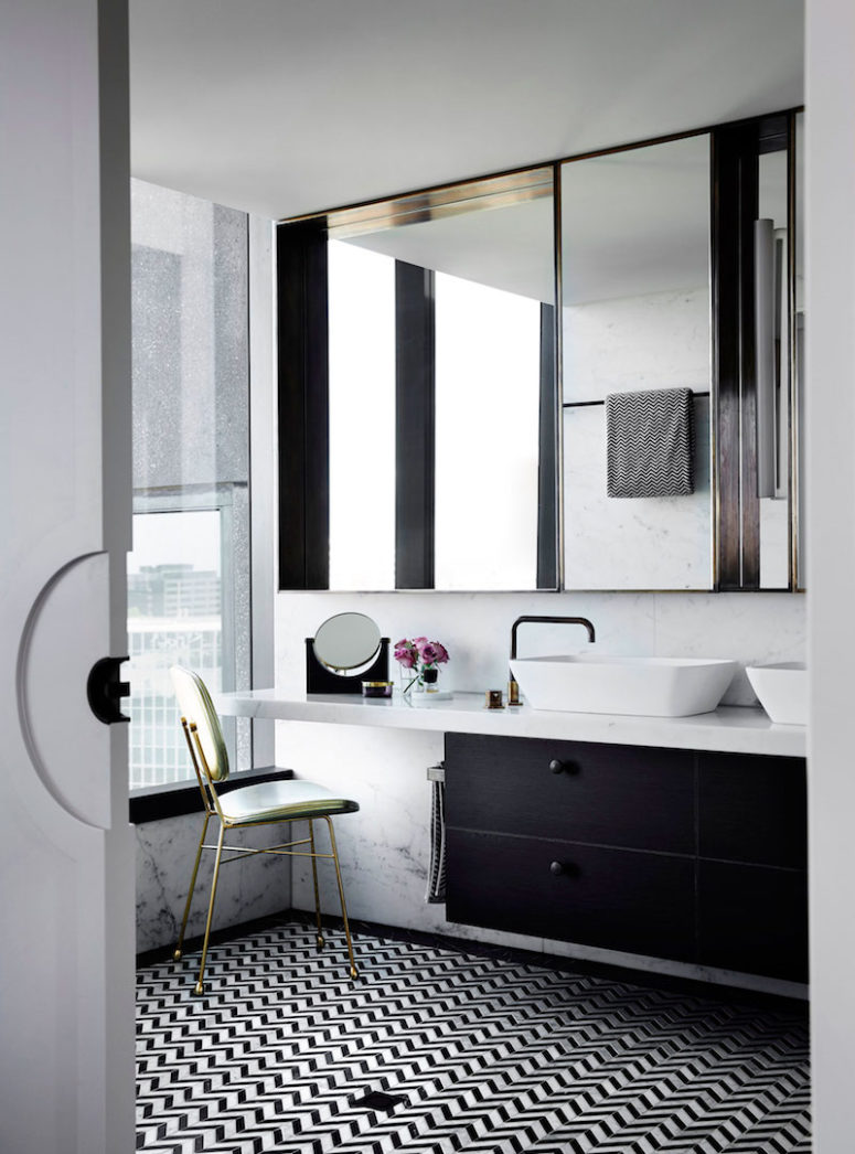 The master bathroom is decorated in tones of black and white with subtle metallic accents