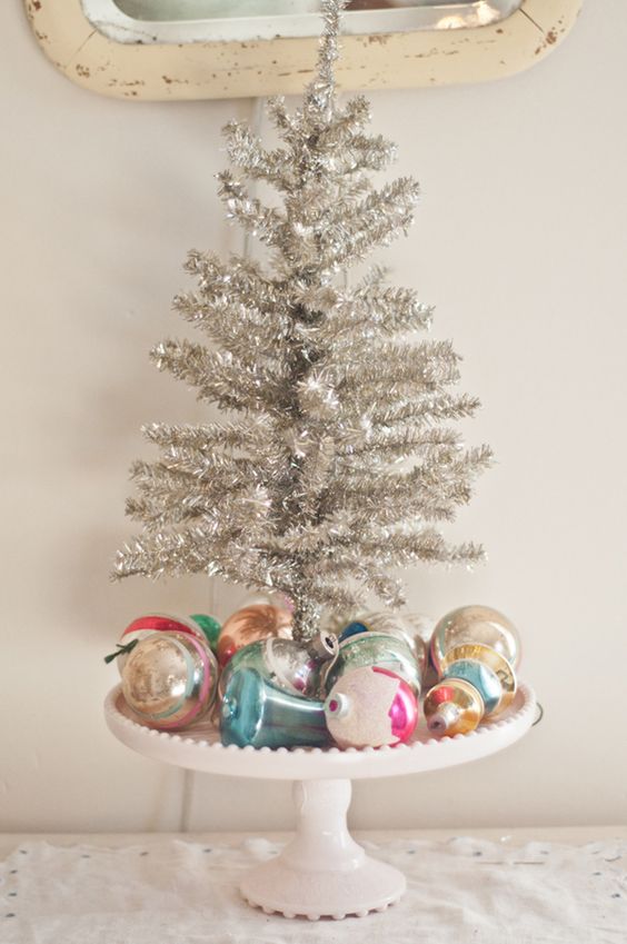 cake stand with ornaments and a small silver tree