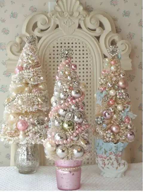 pastel and metallic Christmas trees all decorated with beads and small ornaments