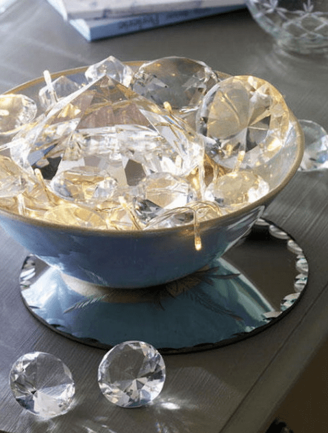 a bowl with string lights and large crystals that reflect the lights