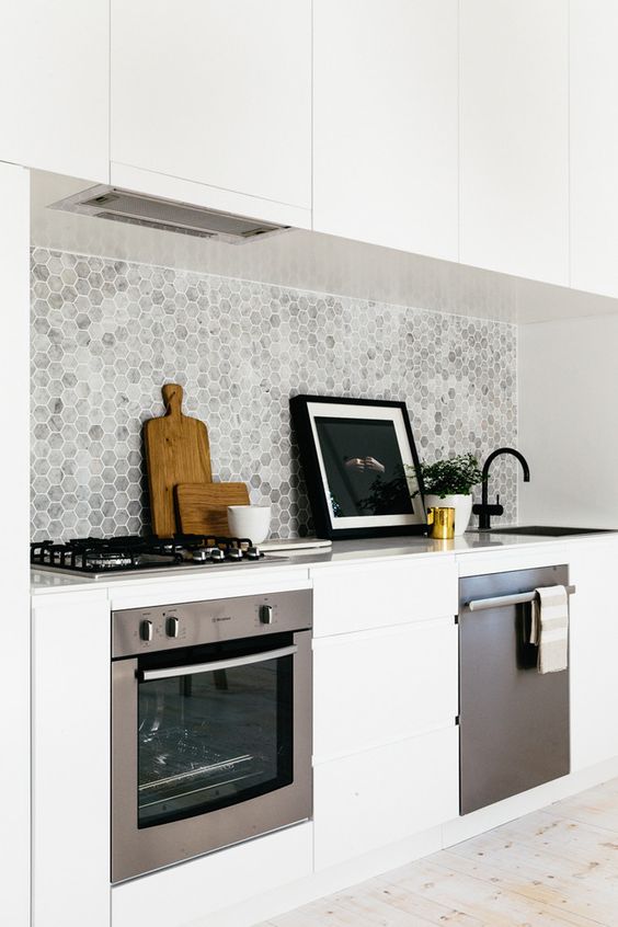 marble grey backsplash contrasts with pure white cabinets