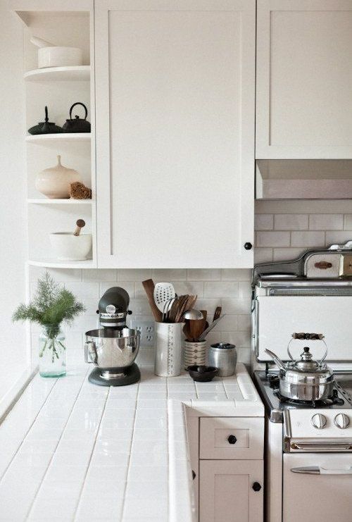 white tiles on the countertops and backsplash, white grout