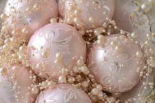 15 a chic bowl with pearls and pastel pink ornaments is a cool delicate display