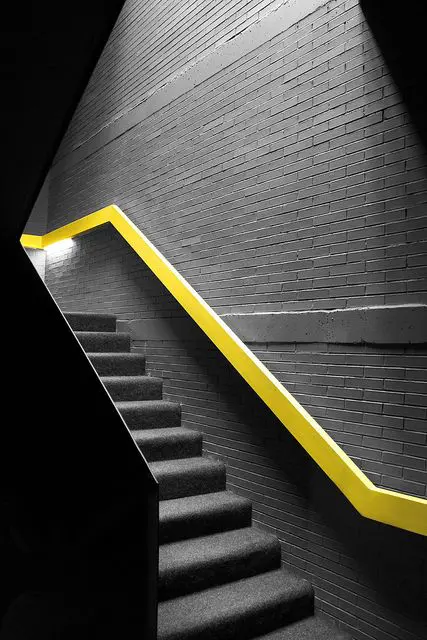 modern neon yellow handrail to contrast with the dark space