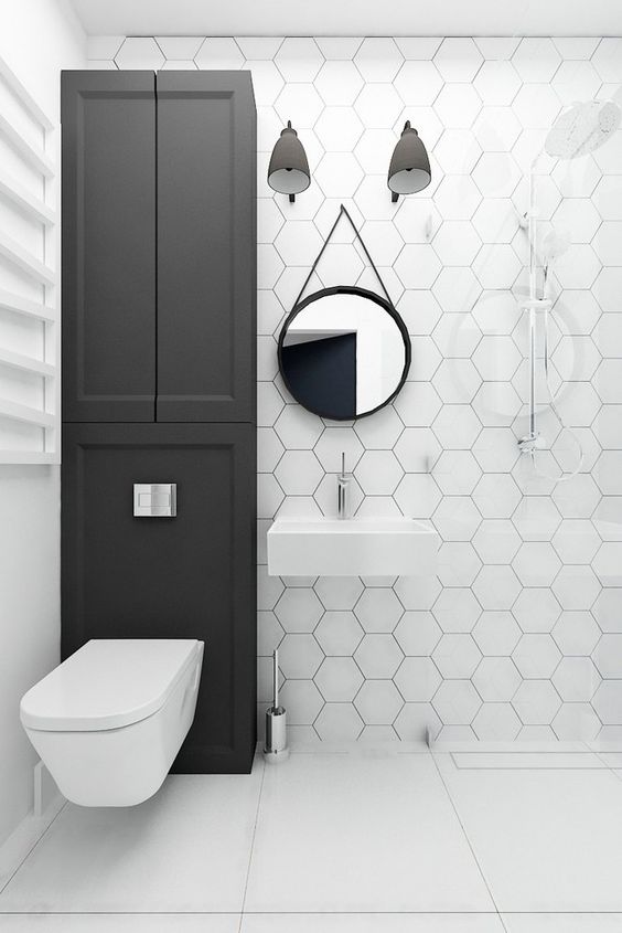 white hex tiles with black grout to highlight it and large square tiles on the floor