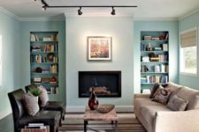 17 track lights accentuate a faux fireplace and artworks