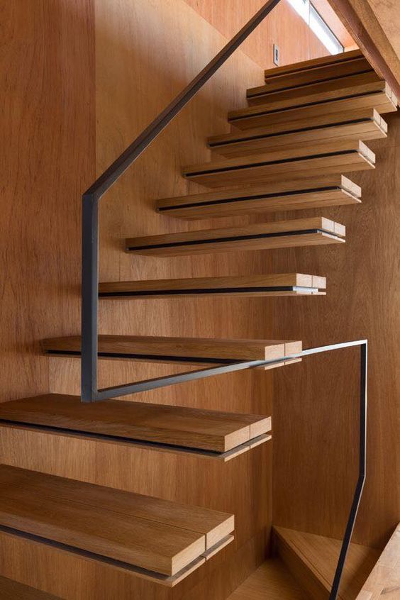 minimalist staircase with a metal handrail and no balustrade