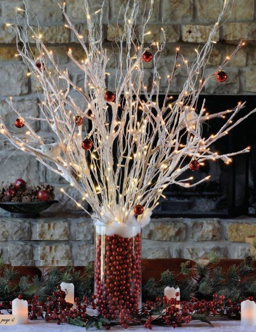 whitewahsed branches with red ornaments and lights