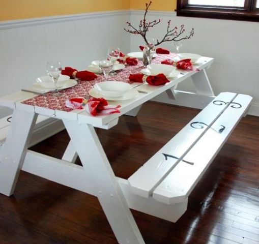 simple white picnic table with red decor looks cool