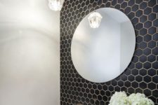 20 small black hex tiles on the bathroom wall with white grout
