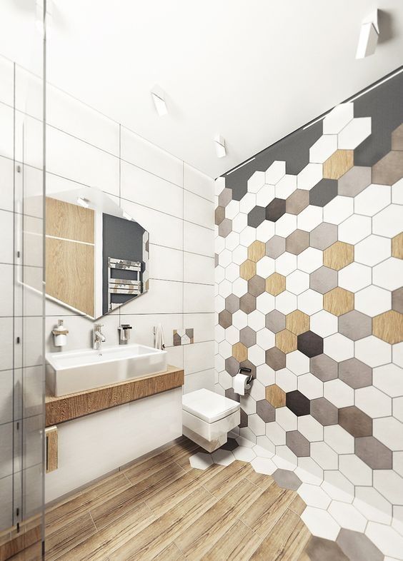 hex tiles mosaics on the wall and wooden floors make the bathroom hoht