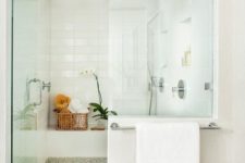 21 luxurious white shower with a frameless glass door and potted flowers