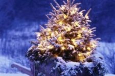 22 lighted and snowy Christmas tree in a wheelbarrow