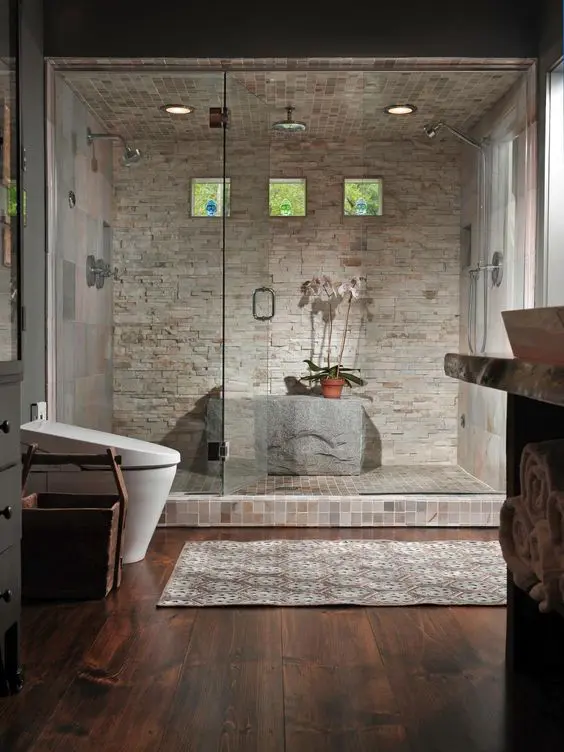 Stone clad steam room with a shower and a large stone instead of a bench