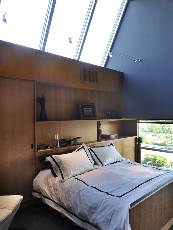 attic bedroom with track lights hanging over the bed