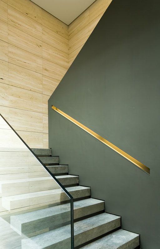 handrail cut out in the wall and decorated with a metal shade
