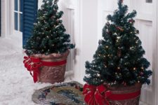 23 mini potted trees with lights and large red bows