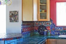 24 very bold teal tiles on the countertops and red and blue tiles on the backsplash