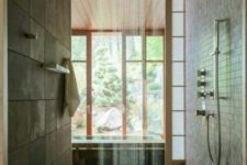 26 East-inspired walk-in shower with wooden floor and a rain shower