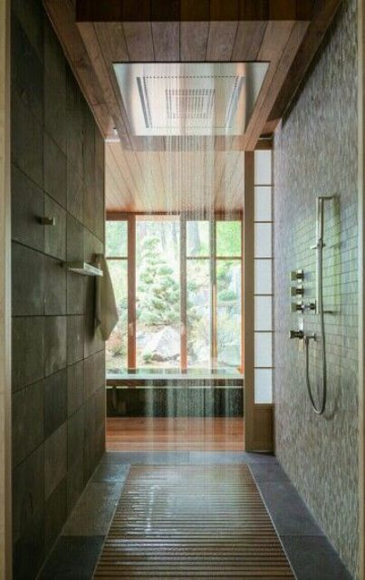 East inspired walk in shower with wooden floor and a rain shower