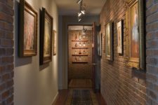 26 industrial hallway with artworks that are highlighted with track lights
