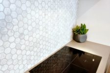 26 neutral mother of pearl hex tile backsplash for a modern kitchen