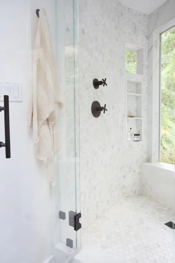 small marble hex tiles all over the shower