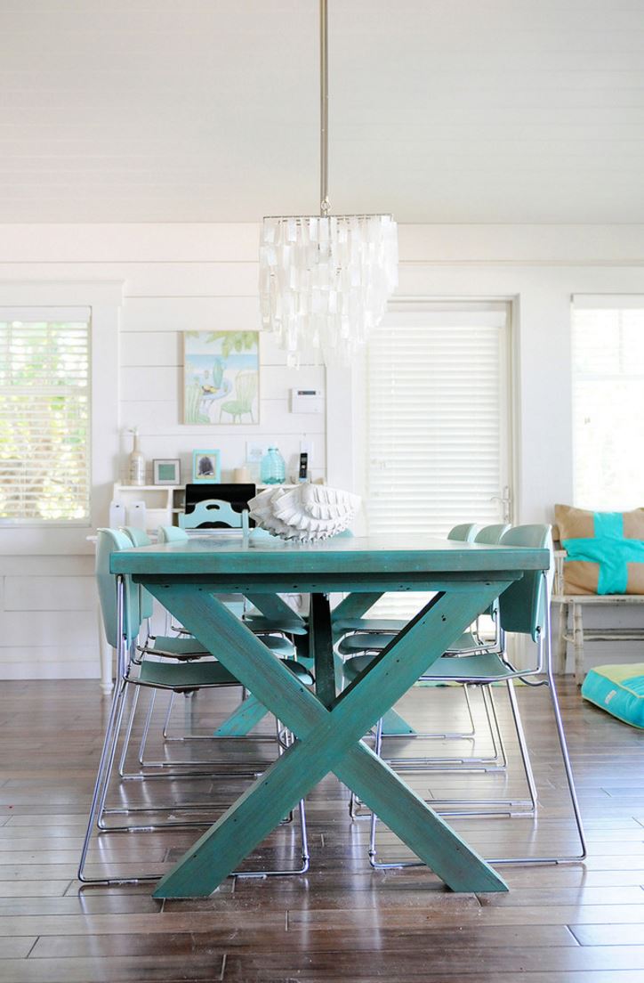 a beachside home can welcome a turquoise table and modern chairs