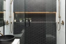 29 black honeycomb tiles in the shower to highlight the zone