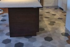 29 hardwood floors and grey mosaic hex tiles to separate a kitchen zone and a dining zone
