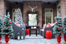 30 snowy faux trees with large glossy red ornaments