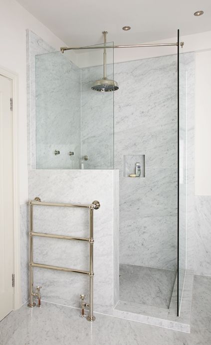 stylish small marble shower with a half wall and glass