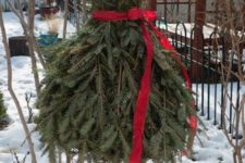 31 Christmas tree shaped as a lady’s dress with a red sash