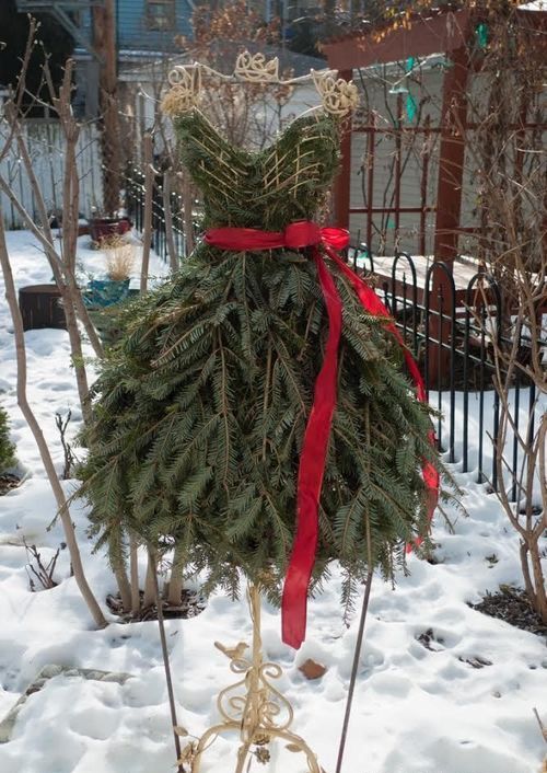 31 Christmas tree shaped as a lady's dress with a red sash
