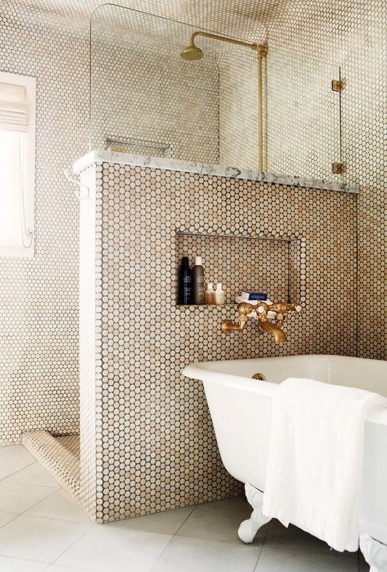 penny tiles cover the whole bathroom and shower, a half wall keeps the excessive water awya