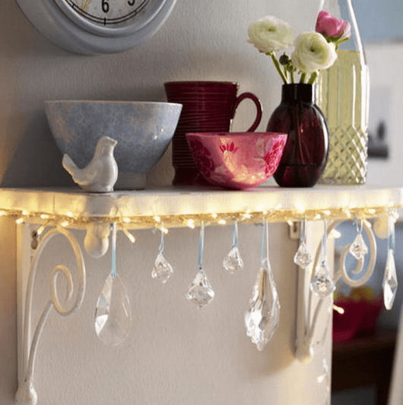 attach string lights and crystals to a small shelf
