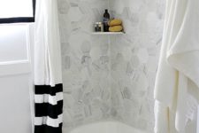 32 grey marble hex tiles over the bathtub