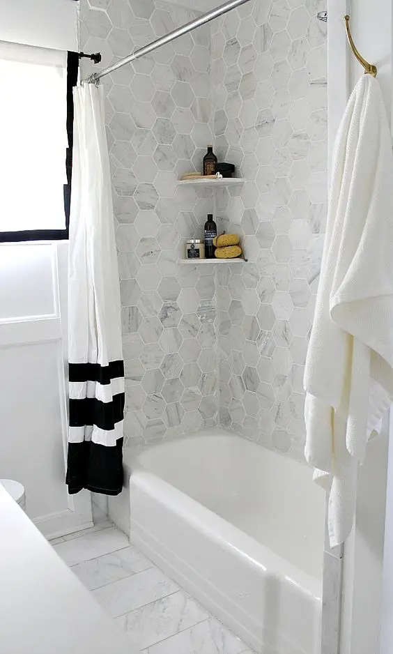 grey marble hex tiles over the bathtub