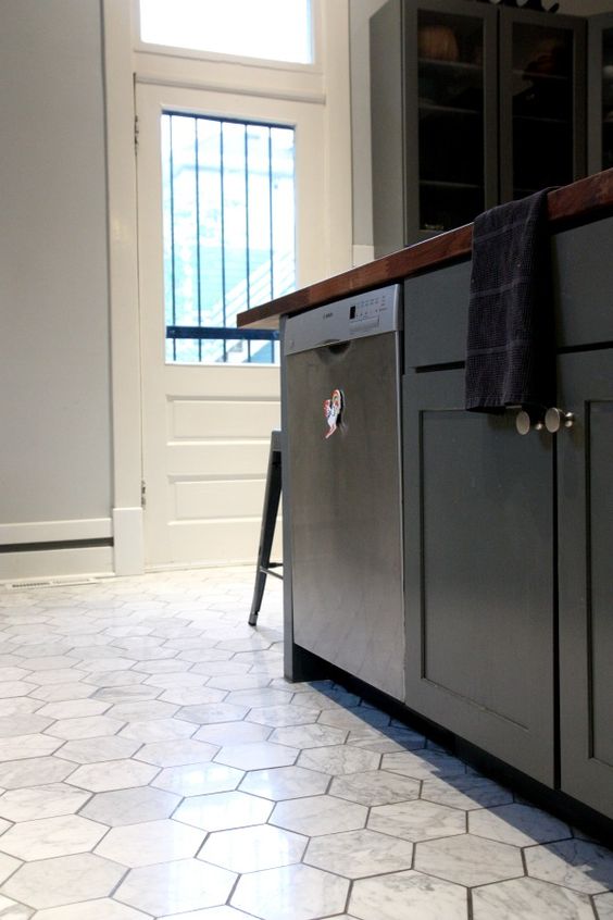 marble hex tile floors make black cabinets stand out